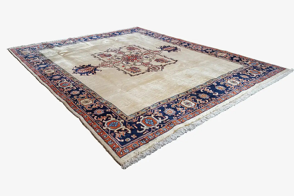 Heriz rug, cream background with cross motif, dark blue border border