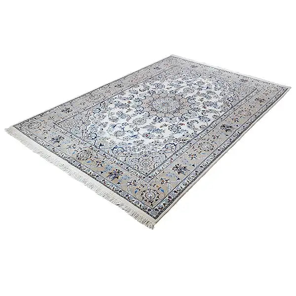 Rectangular oriental rug, cream-colored background with a blue ornamental pattern and fringes