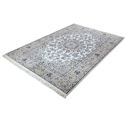 Rectangular oriental rug, cream-colored background with a blue ornamental pattern and fringes