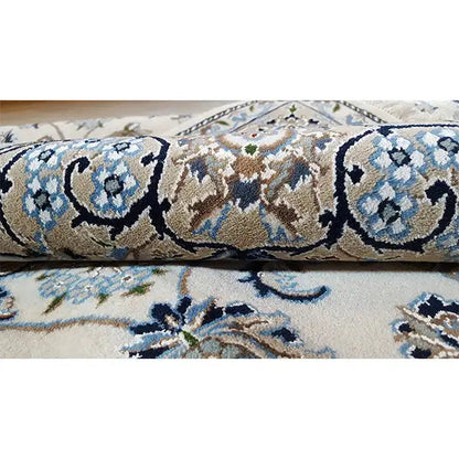 Oriental rug with twisted pile: blue-and-white vine motifs, side edge with border
