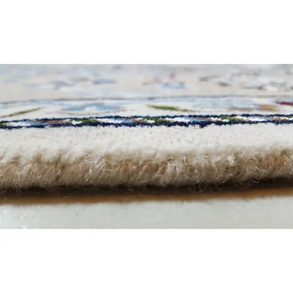 Oriental rug view from the side: dense, plush pile with a fine border edge