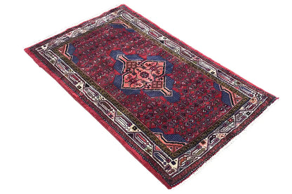 Oriental rug in red and dark blue, diagonal view, large medallion in the center