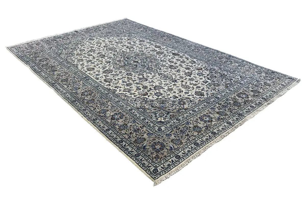 Beige oriental rug with a dark blue patterned field and border, draped into a triangle
