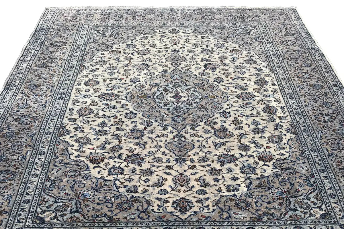 Oriental rug with a large central medallion, delicate blue and beige ornaments, and framing borders