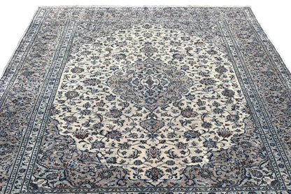 Oriental rug with a large central medallion, delicate blue and beige ornaments, and framing borders
