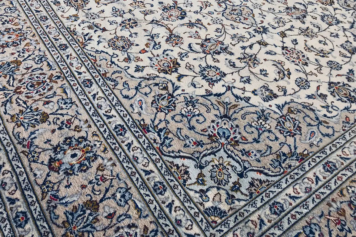 Oriental rug corner with border stripe and blue pattern on a light background