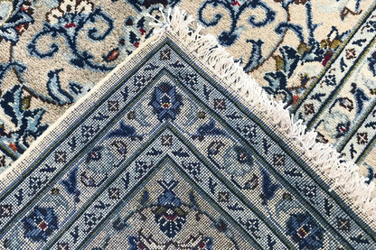 Close-up: fringes along the edge and a blue geometric and ornamental pattern