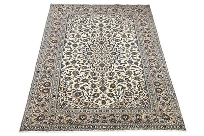 Beige rug with border and detailed ornamentation, central medallion frame