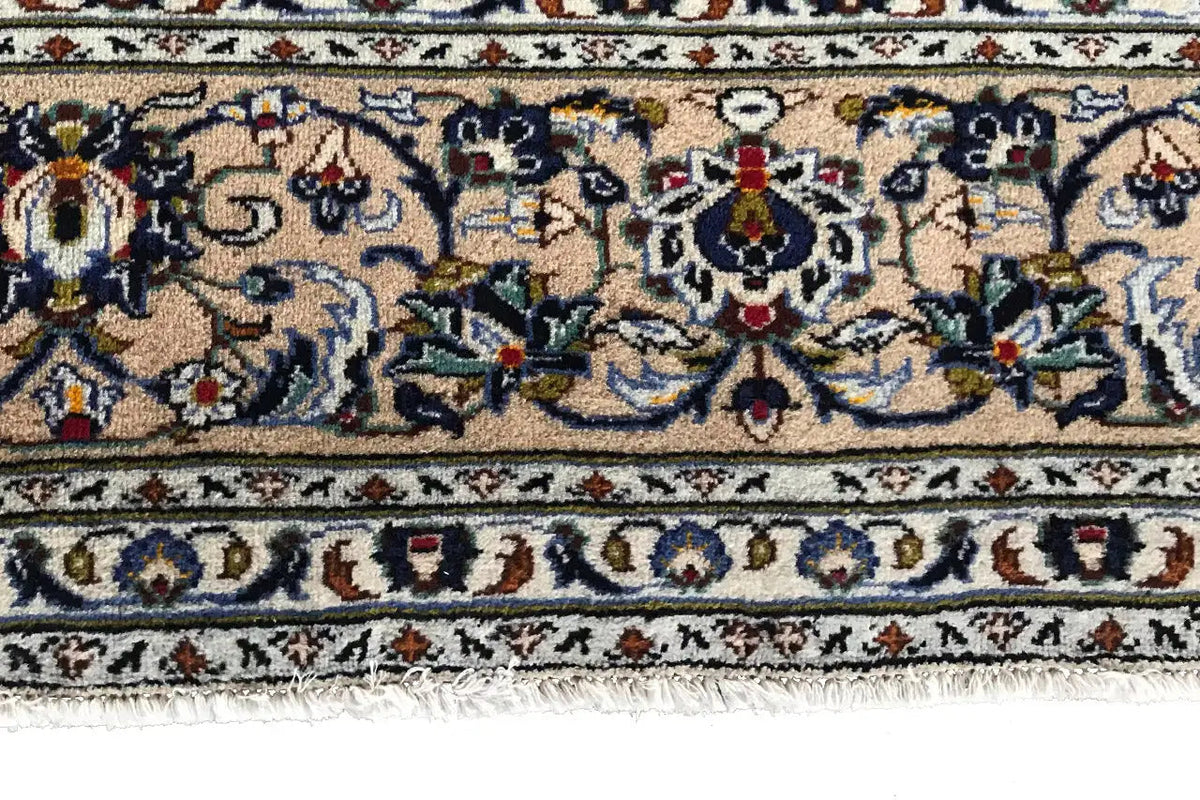 Carpet detail with floral ornaments and multicolored border, edge with fringes