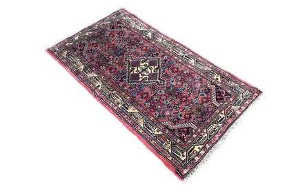 Hamadan rug 135x77 cm angled view: red background pattern with dark blue and ornaments
