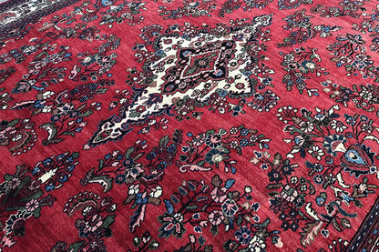 Hamadan rug with a red background and baroque floral and medallion patterns