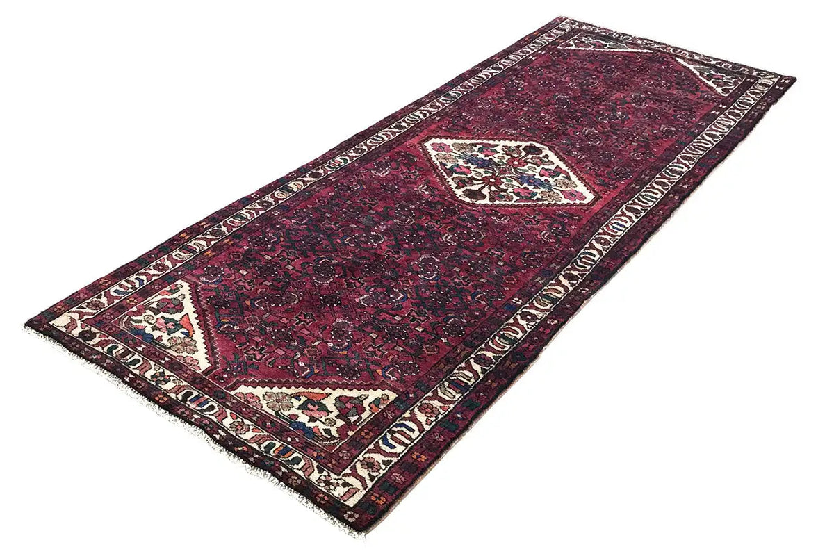 Hamadan runner with a red ground and border pattern, central medallion, rectangular border