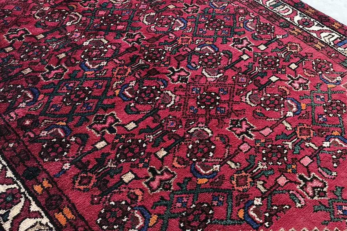 Hamadan runner with a red ground and a dense pattern of vines and small ornaments