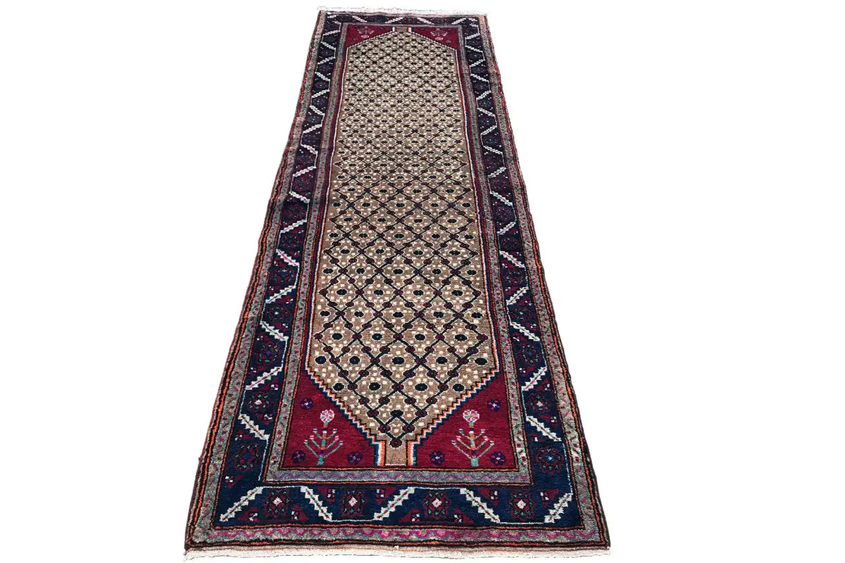 Oriental rug runner with a beige medallion, dark blue and burgundy border