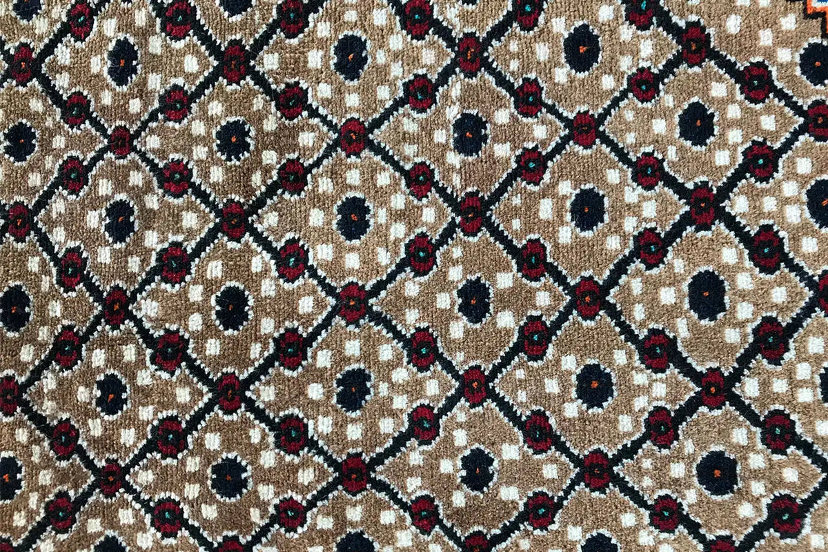Close-up: Diamond and circular motifs in beige, dark blue, and burgundy