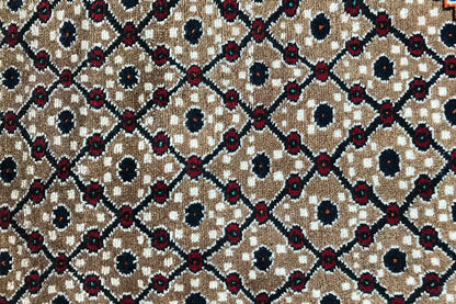 Close-up: Diamond and circular motifs in beige, dark blue, and burgundy