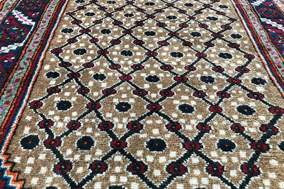 Oriental rug runner corner with a blue and burgundy border and beige pattern