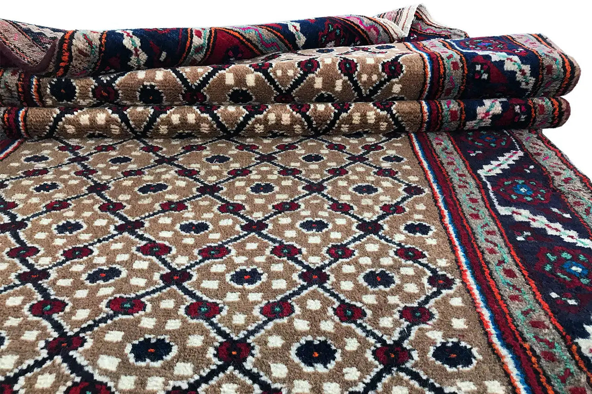 Folded Oriental rug runner with a beige pattern and a blue-and-burgundy border