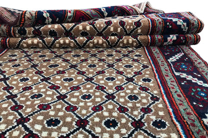 Folded Oriental rug runner with a beige pattern and a blue-and-burgundy border
