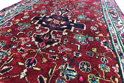 Hamadan runner detail view: red medallion ornament with colorful small motifs
