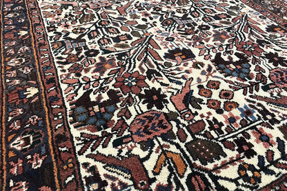 Oriental rug runner with a multicolored ornamental pattern, dark border, and fringe