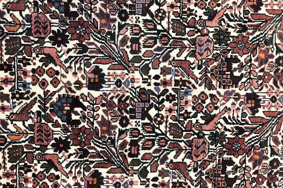 Runner rug with a dense pattern of diamonds and floral ornaments in beige, red, and blue