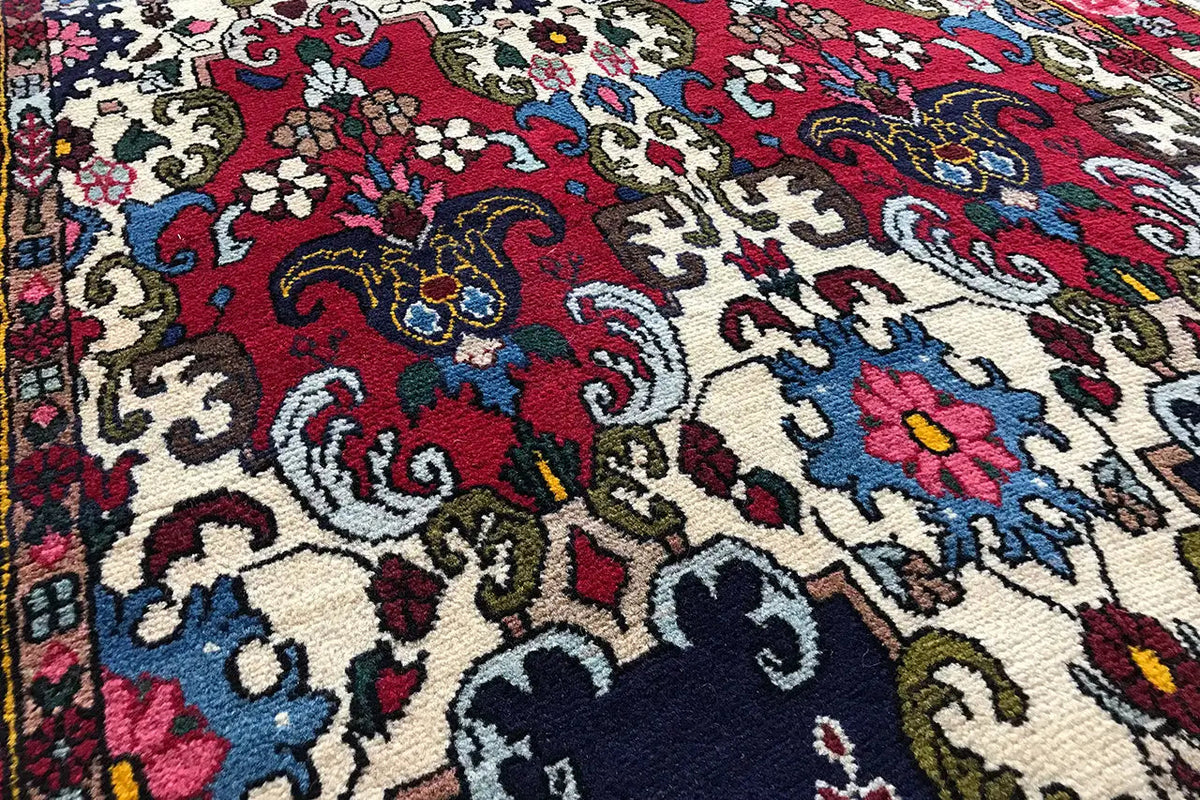 Bakhtiari rug with a colorful ornamental pattern in red, blue, and beige (close-up)