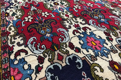 Bakhtiari rug with a colorful ornamental pattern in red, blue, and beige (close-up)