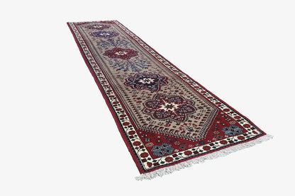 Rectangular runner with border and medallion patterns in red, blue, and beige