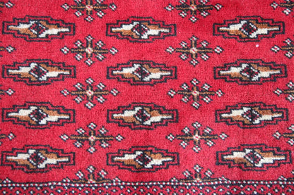 Poshti Turkmen carpet: close-up of geometric patterns in red, blue, and beige