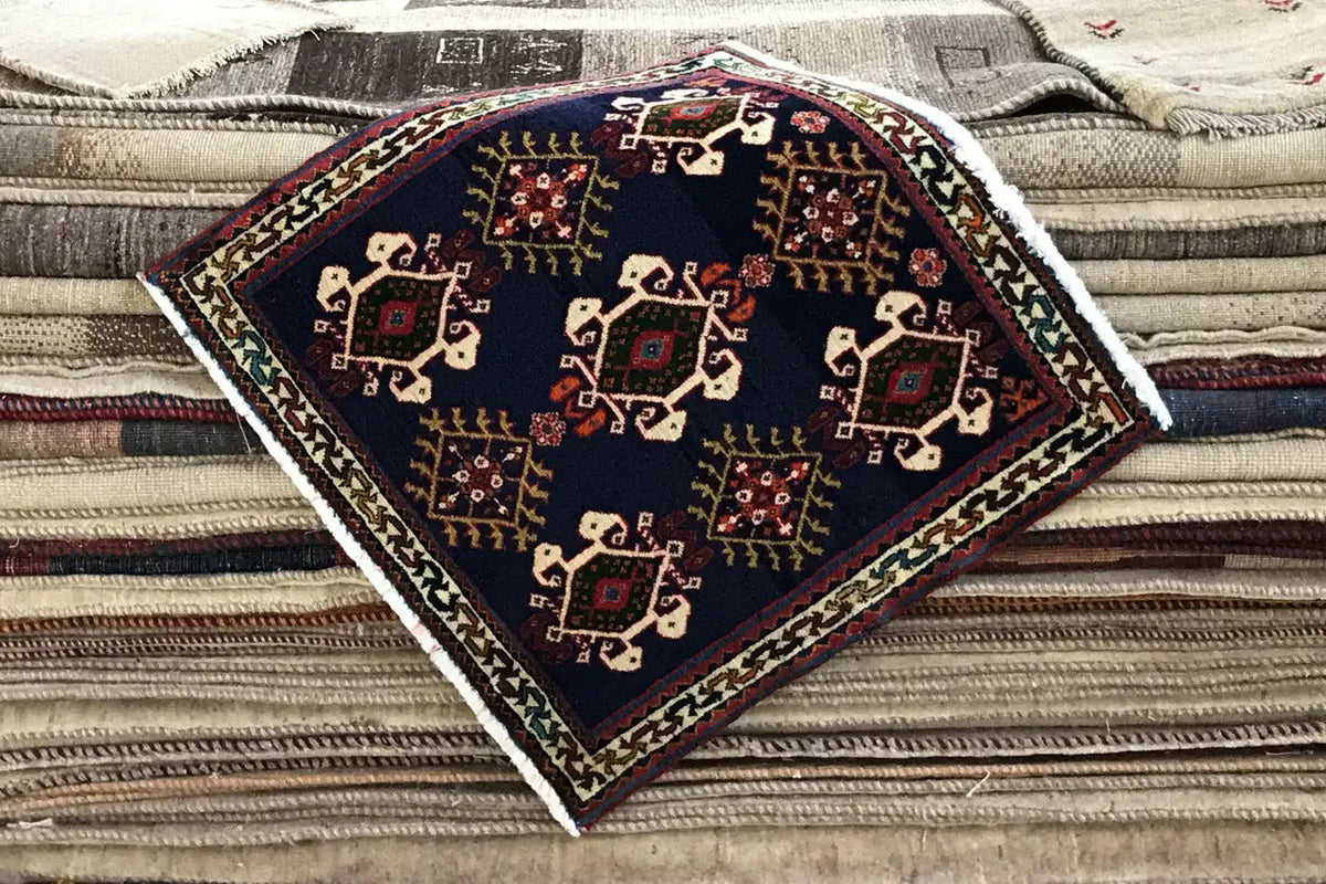 Rug 61x60 cm, dark blue, on folded textile, with ornaments and borders