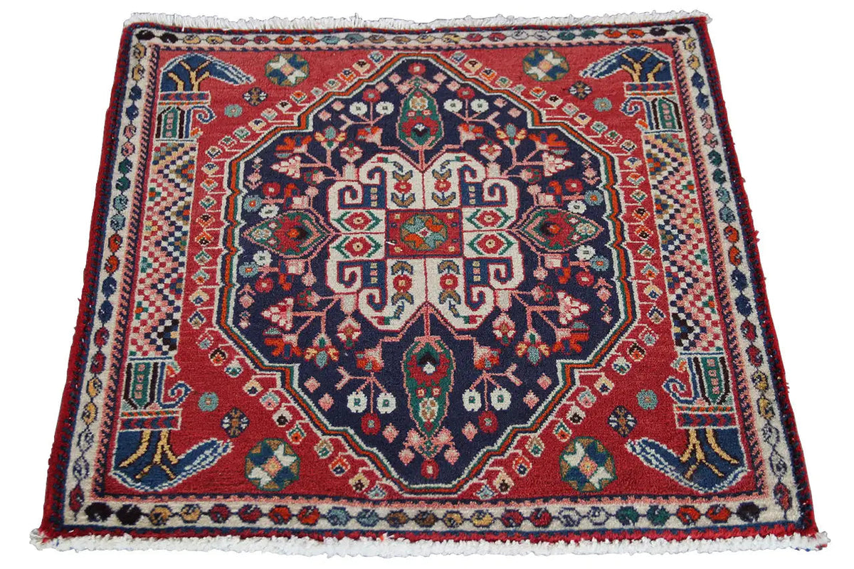 Oriental rug with a red central medallion, blue ornamental pattern, and multicolored border