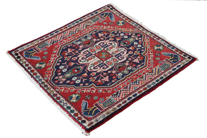Square Oriental rug with a red background, dark blue pattern, and white fringed border