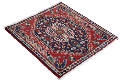 Square oriental rug, red background with blue-and-white ornaments and a border frame