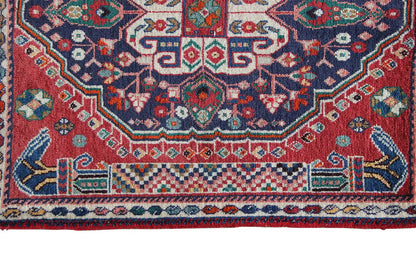 Detail of the carpet border: blue ornamental band with decorative lines and fringed edge