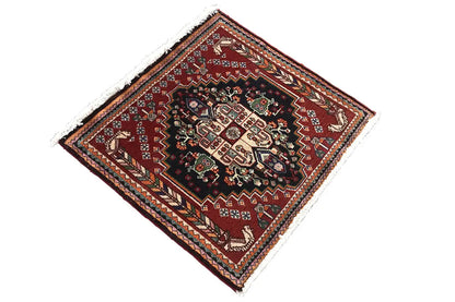 Square oriental rug, central medallion on a black ground, burgundy border frame