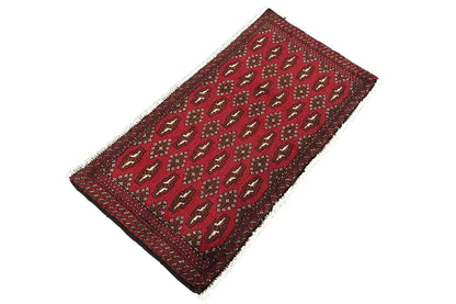 Poshti Turkmen carpet (95x47 cm), red, appearing rolled lengthwise, with a repeating pattern