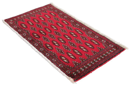 Triangular red Turkmen rug with ornaments and white fringes