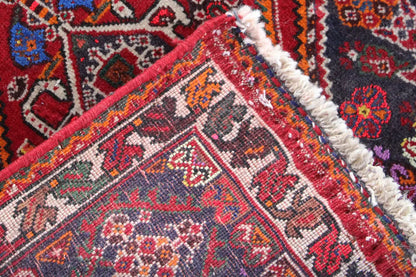Close-up of a carpet detail: woven pattern with a fringed edge and alternating colored rows.