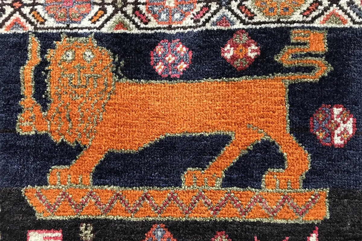 Qashqai rug detail: orange and dark blue animal motifs with colorful medallions