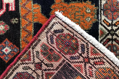 Qashqai rug corner with fringed trim, multicolored patterned border