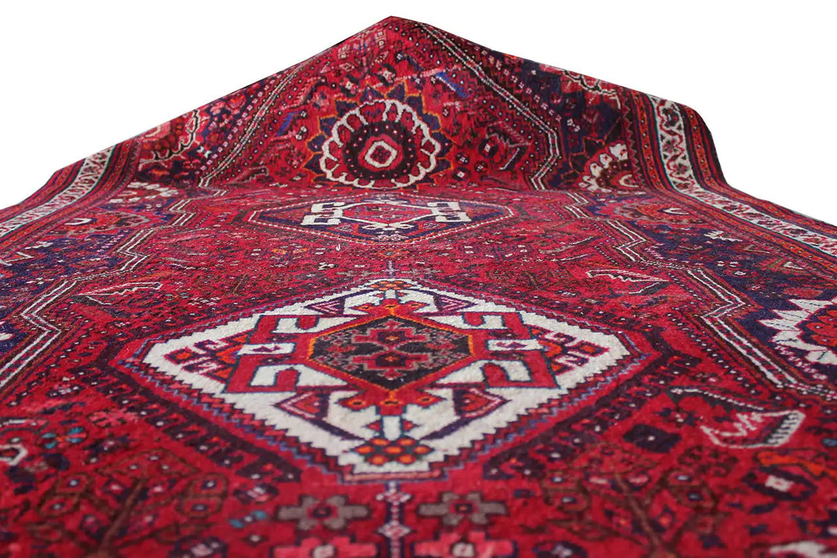 Oriental rug runner, red patterned weave with white and dark blue accents, top view
