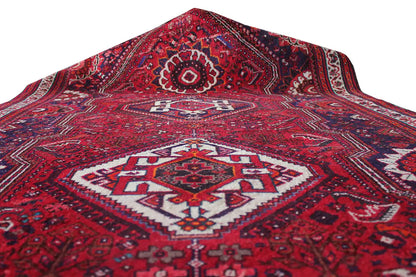 Oriental rug runner, red patterned weave with white and dark blue accents, top view