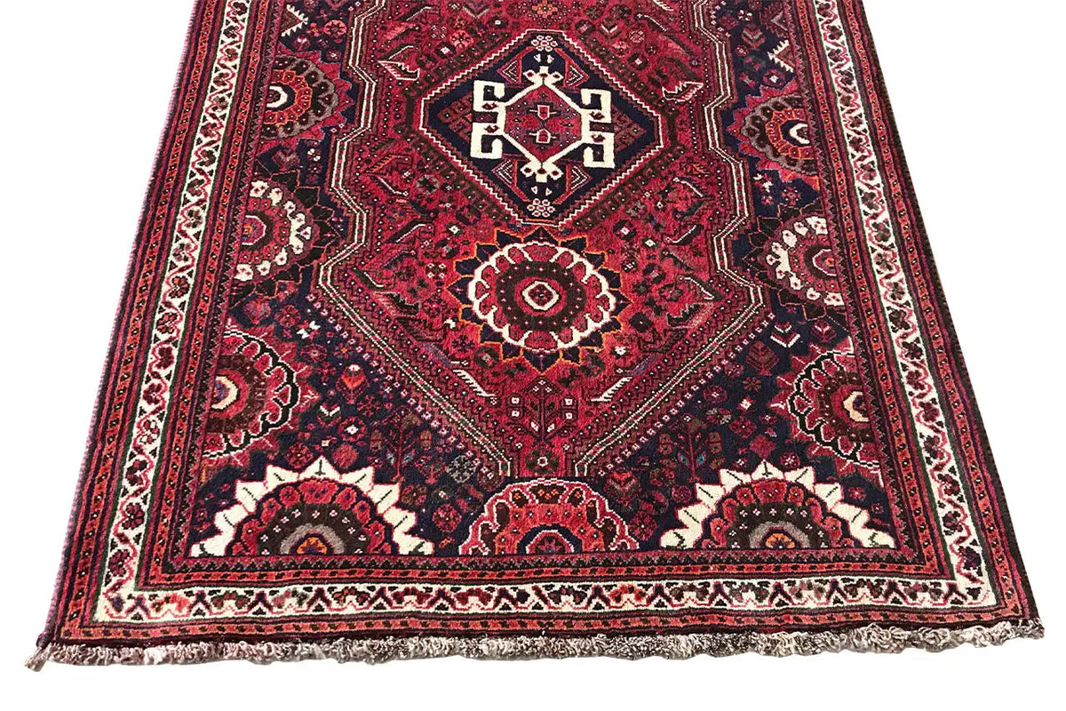 Oriental rug runner with a square ornamental medallion, red background, border trim