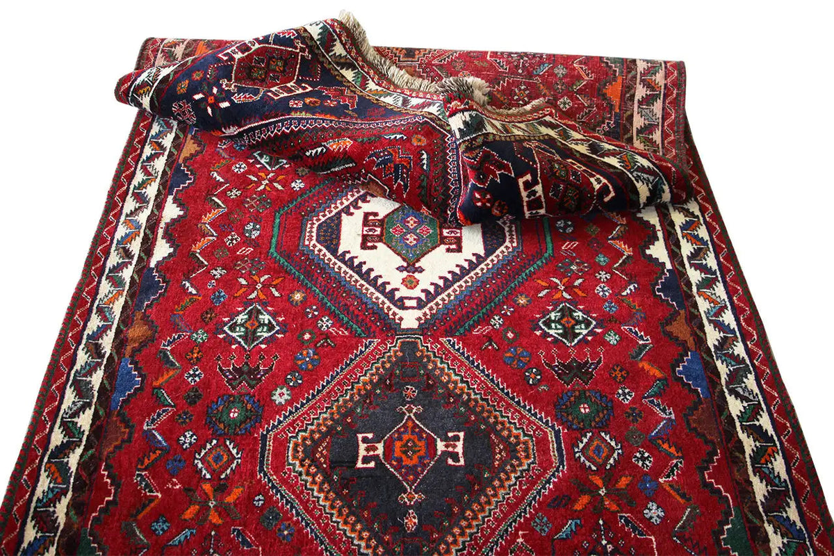 Crumpled Oriental runner rug, red pattern with a central diamond and blue/white decorative border