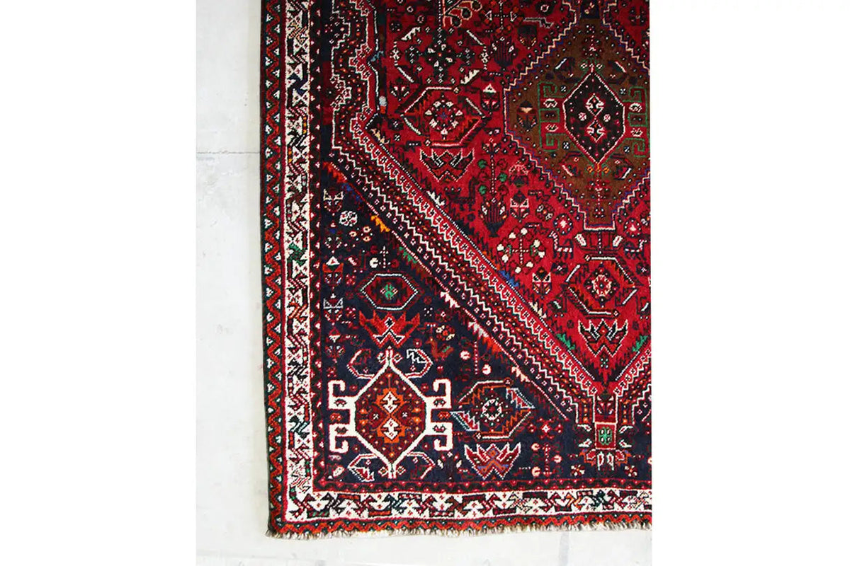 Red-and-blue runner with borders and ornaments, close-up at the edge