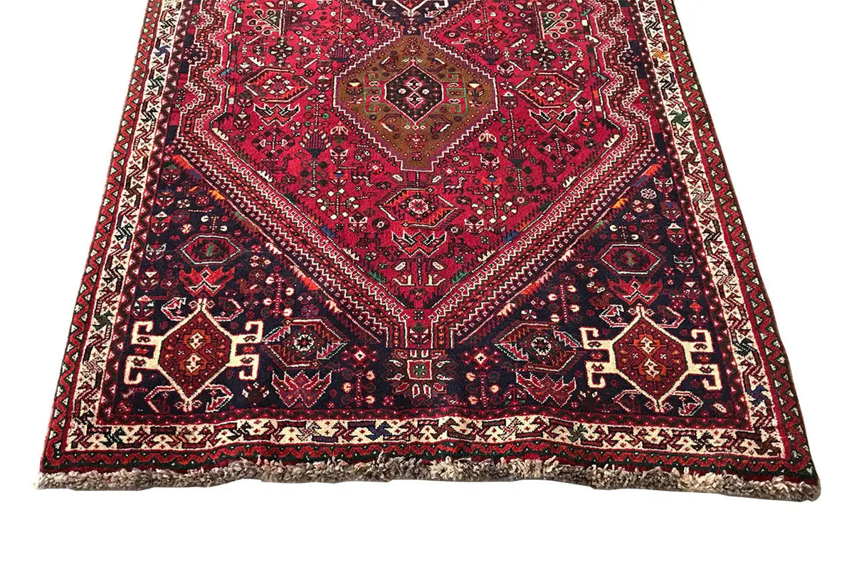Red-and-blue runner with a symmetrical medallion and decorative border