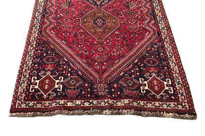 Red-and-blue runner with a symmetrical medallion and decorative border