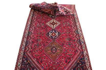 Red runner with ornaments and borders, folded with a visible edge