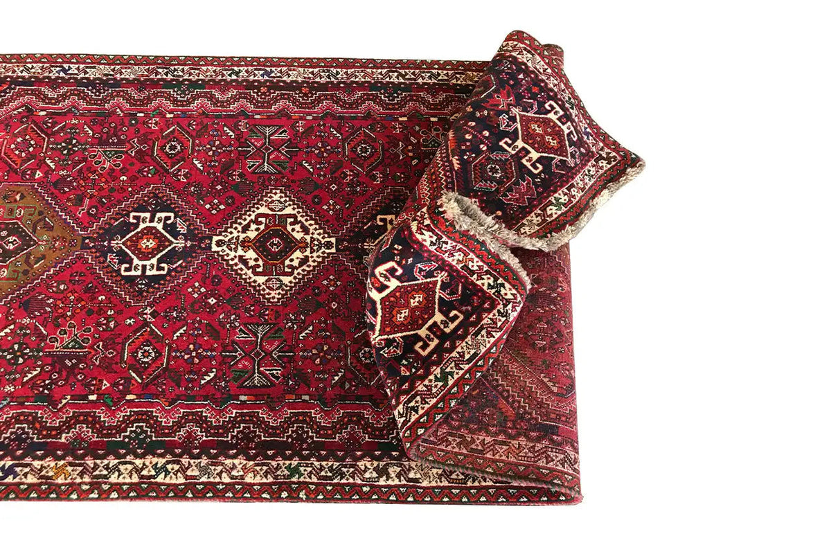 Red runner with folded edges and traditional patterns